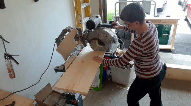 Brenda cutting rough cut pine boards to length